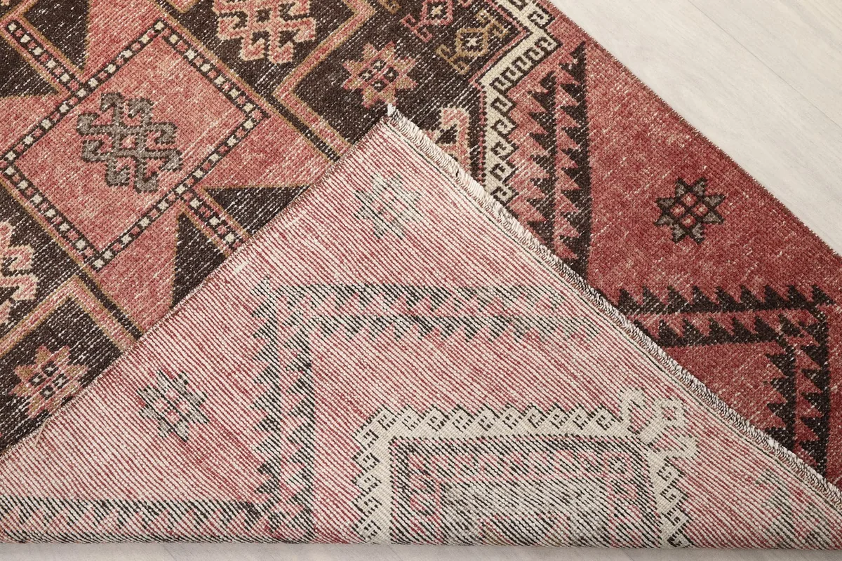 View of the back of the hand-knotted wool rug, showing the cotton foundation.