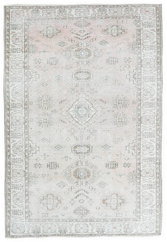 Full overhead view of a vintage rose and beige geometric Anatolian rug