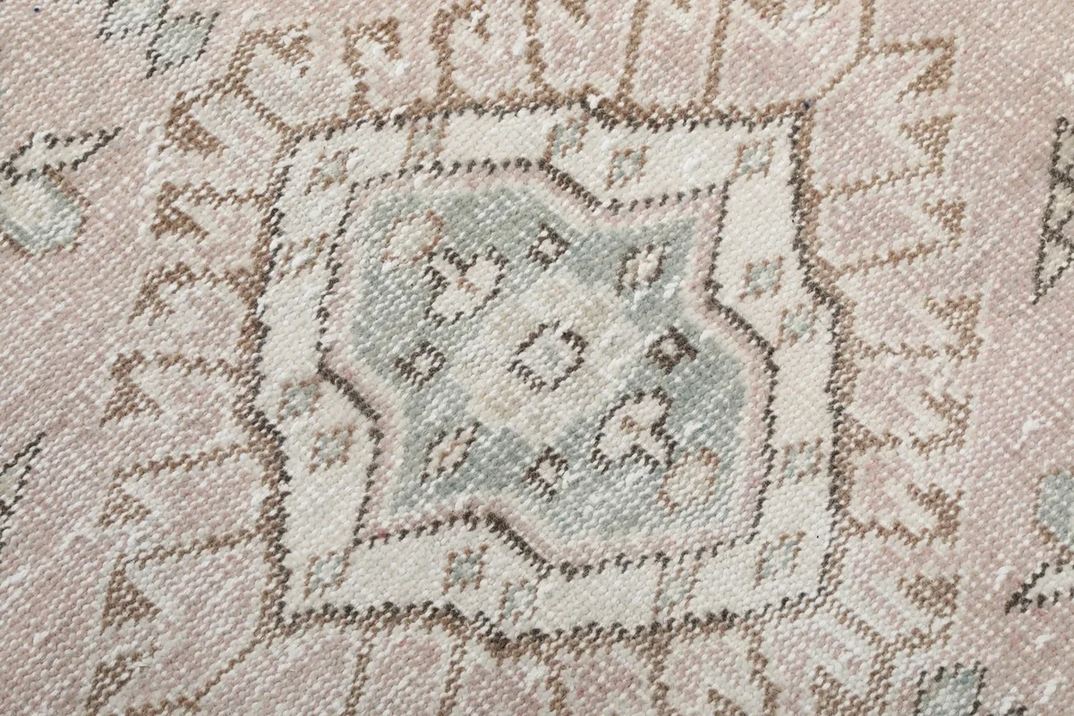 Detailed view of a central geometric motif with blue and beige colors