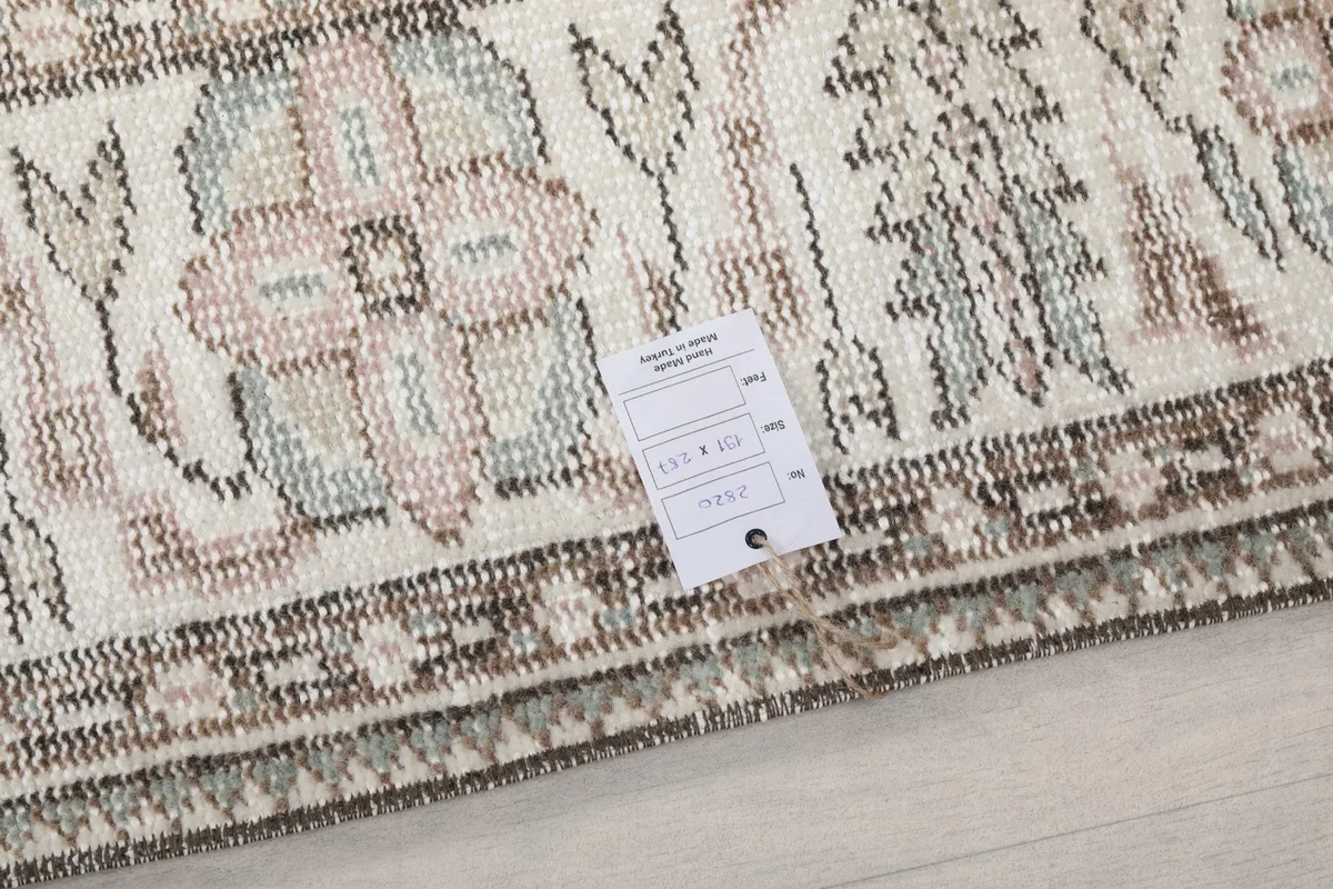 Close-up of the low wool pile and a label showing rug details