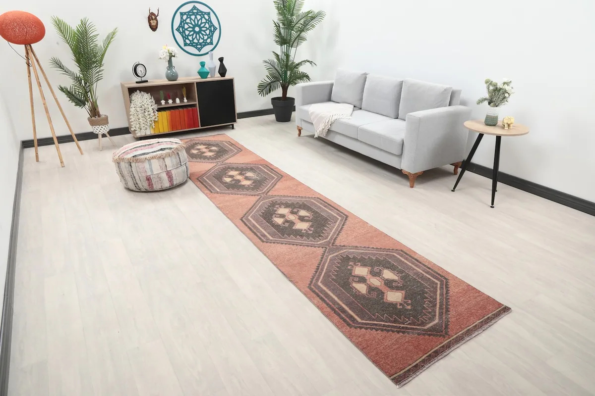 Angle view of the rust runner in a living room, highlighting its placement along a sofa.