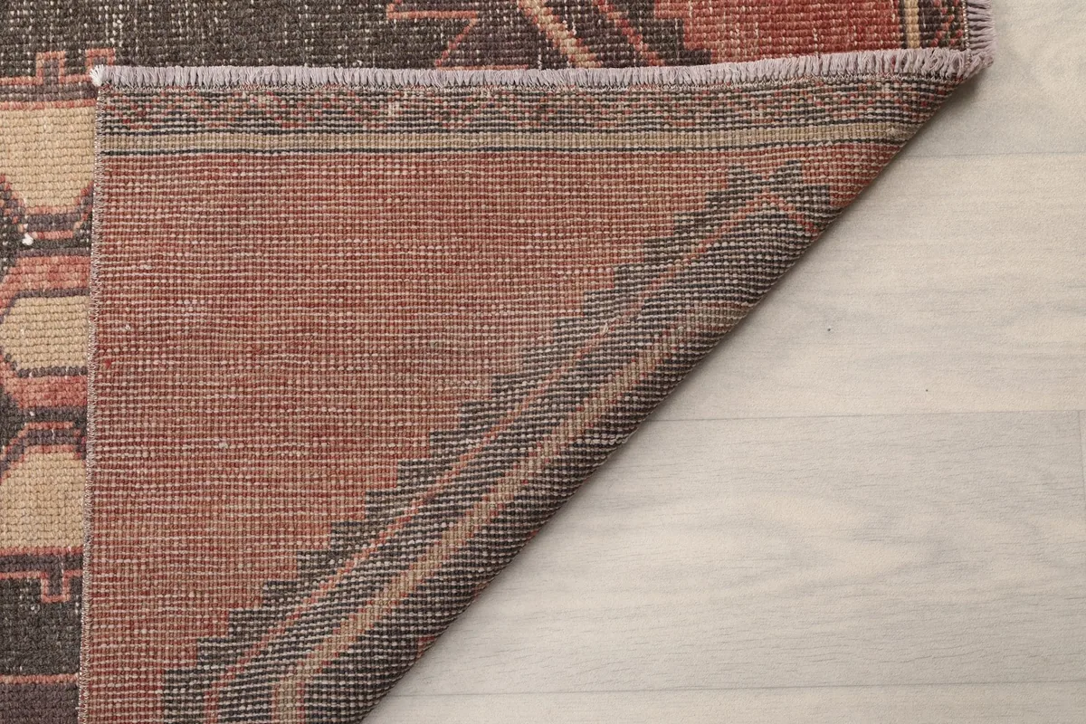 Another view of the back of the rug, showing the dense knotting and cotton foundation.