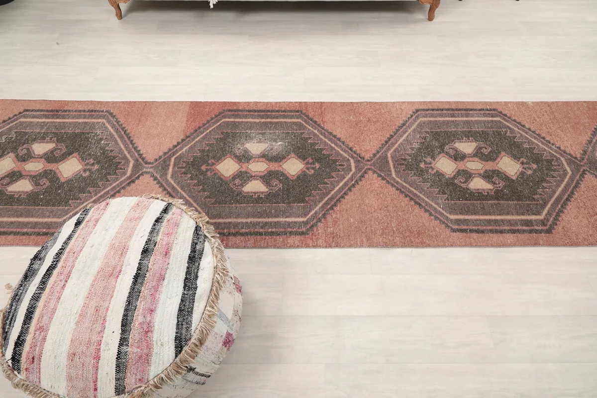 Overhead shot of the runner's central section, emphasizing the series of charcoal and beige medallions.