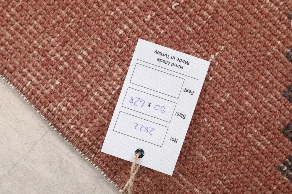 Tag showing the rug's dimensions (90 x 428 cm) and origin as hand-made in Turkey.