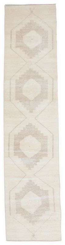 Full overhead view of the 2'9" x 12'6" cream and tan geometric runner rug on a white background.