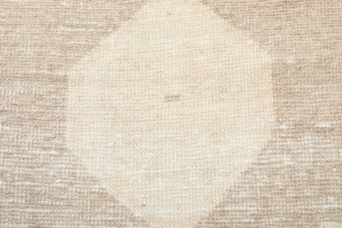 Close-up of the lighter cream area within a geometric motif, illustrating the color variation and texture.