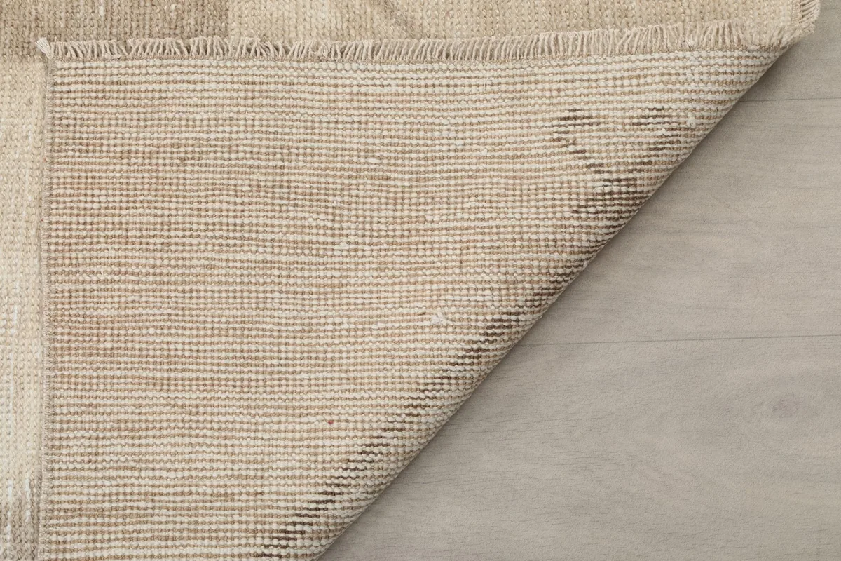Fuller view of the rug's underside, displaying the consistent knotting and the robust cotton foundation.