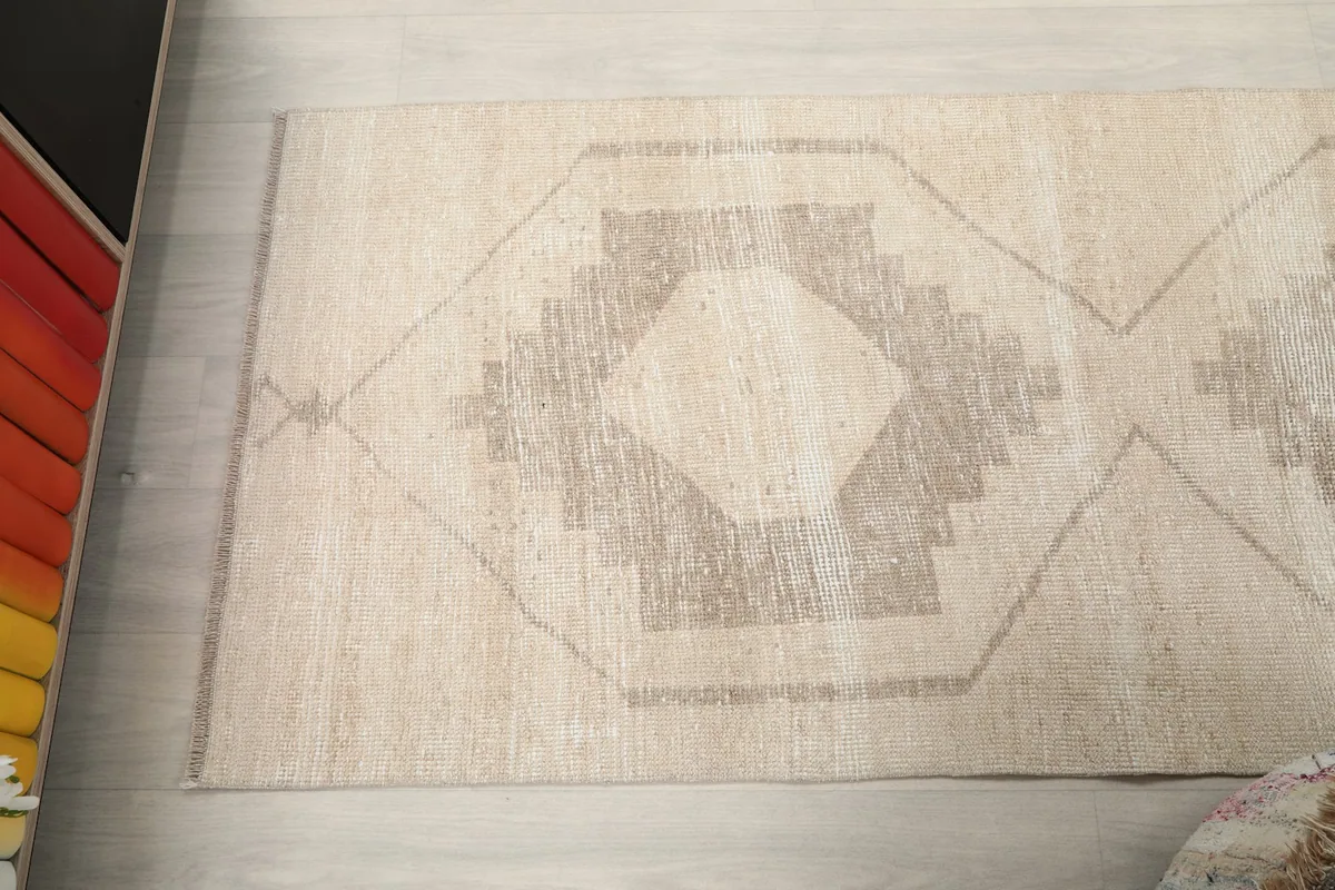 Overhead shot of a section of the runner rug, focusing on a single geometric motif and its surrounding field.