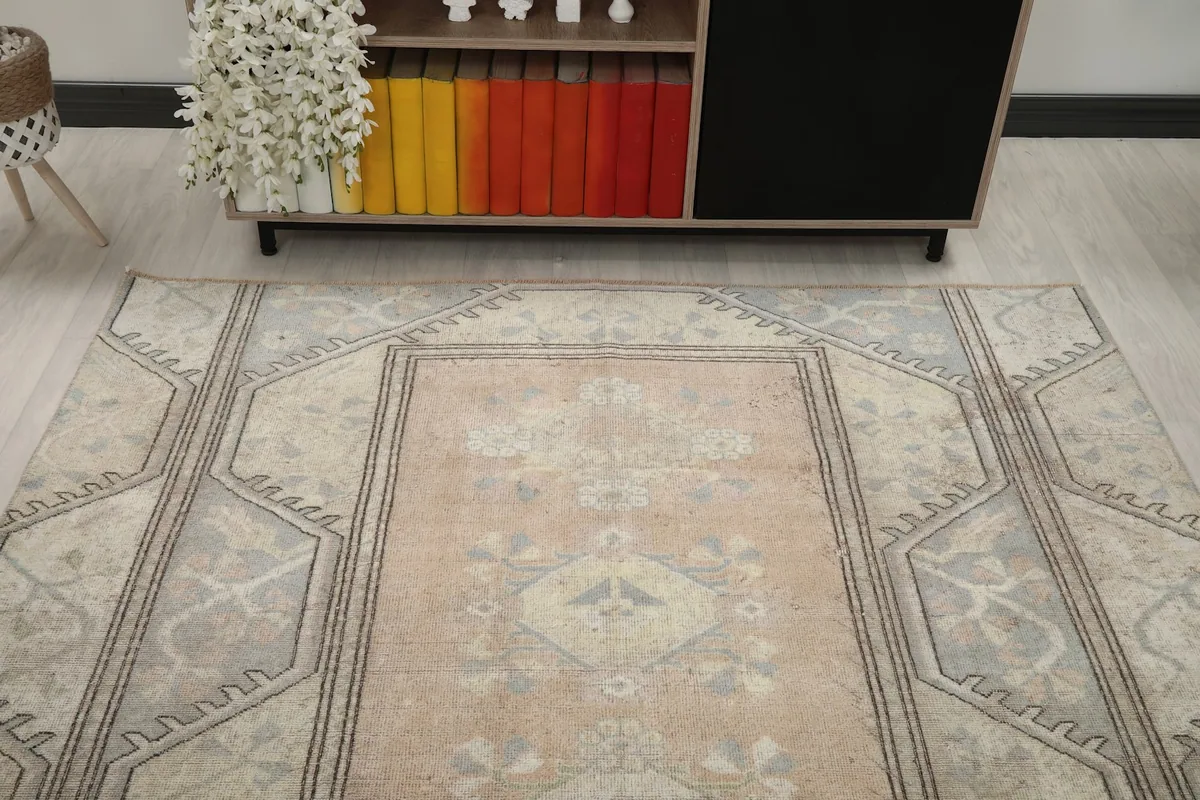 Overhead view of the rug's top half, showing the rose field and gray border patterns