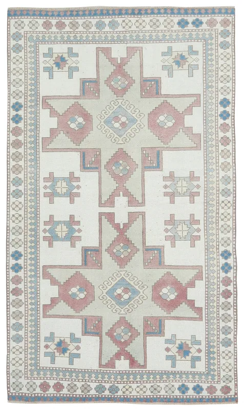 Full top view of the vintage ivory, rose, and blue geometric Anatolian rug