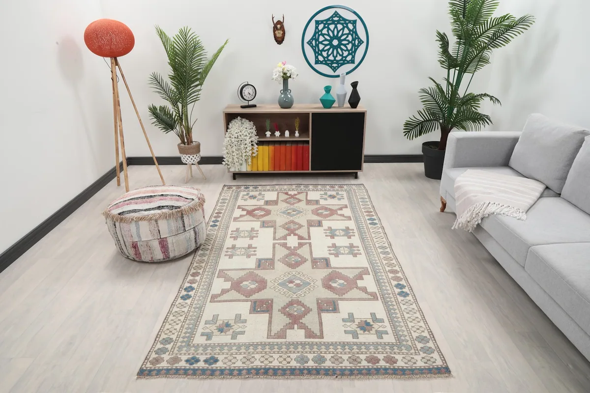 Vintage Anatolian rug displayed in a living room setting with a sofa and decor