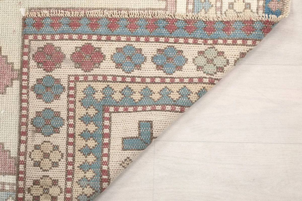 Another view of the rug's reverse side, showing the intricate knotting and fringe