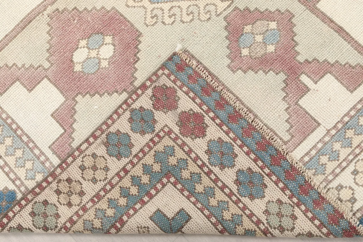 Folded corner of the rug revealing the backside of the hand-knotted construction