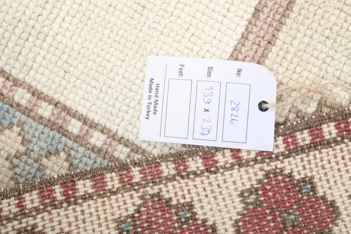 Close-up of the care tag indicating 'Hand Made in Turkey' and rug dimensions
