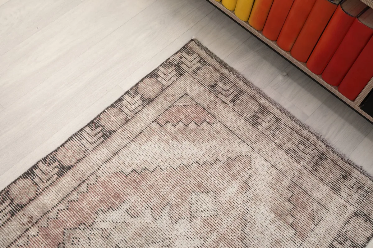 Corner detail of the runner rug, focusing on the border design and color variations