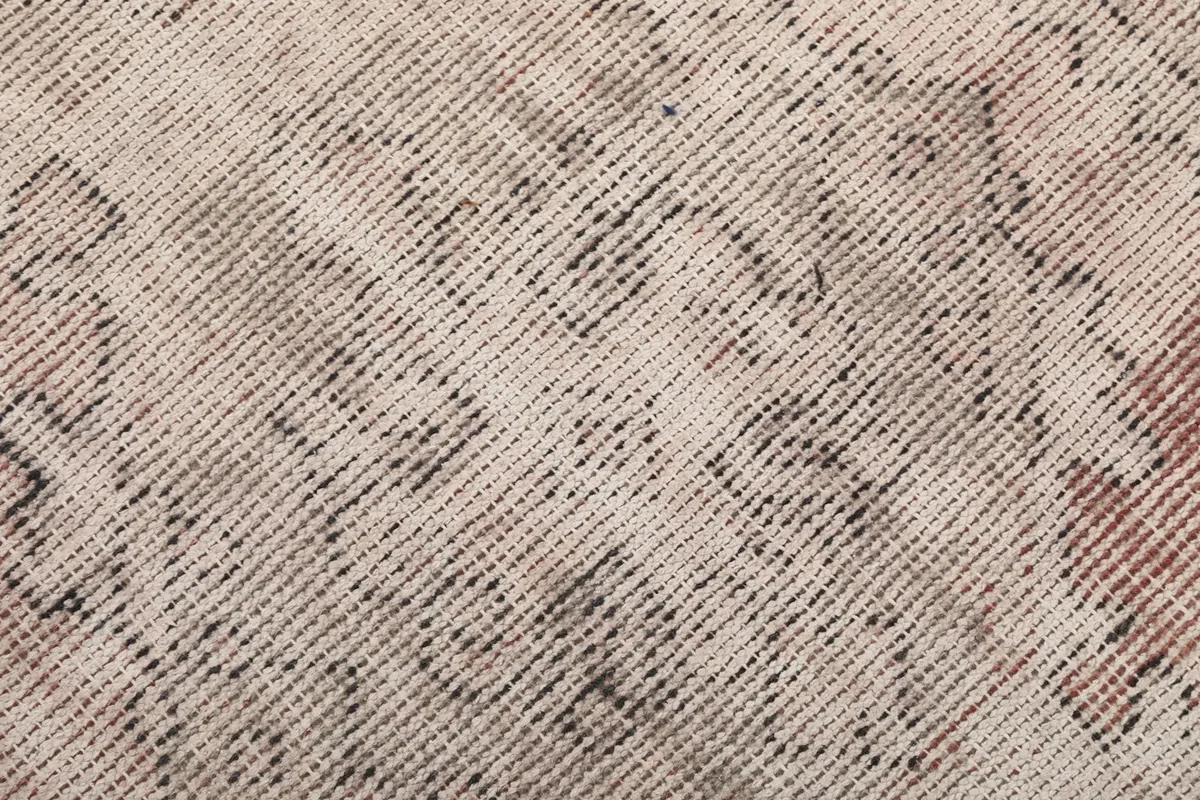 Texture detail of the low wool pile, showing the hand-knotted construction