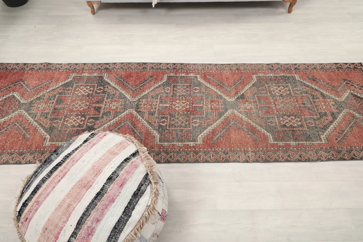 Runner rug laid out in a long room, providing a sense of scale and proportion