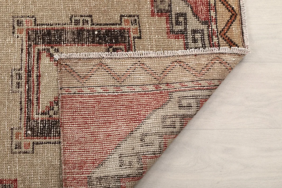 Close-up of the low wool pile and hand-knotted texture of the vintage runner