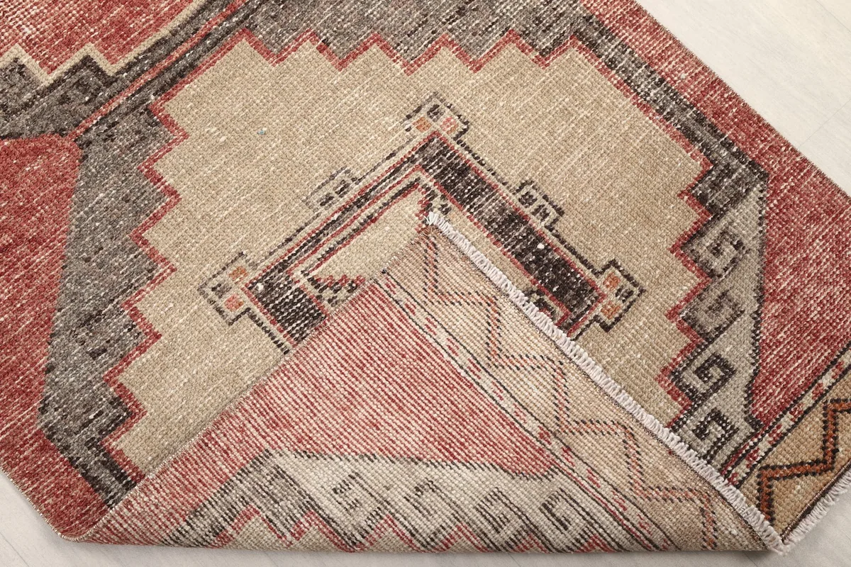 View of the back of the hand-knotted wool rug, showing the cotton foundation