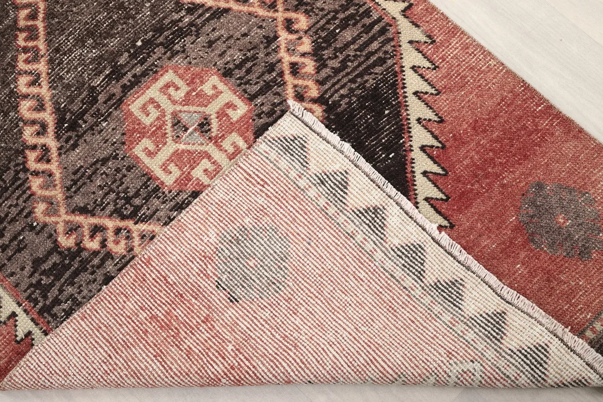 View of the back of the hand-knotted wool rug, showing the cotton foundation and knotting
