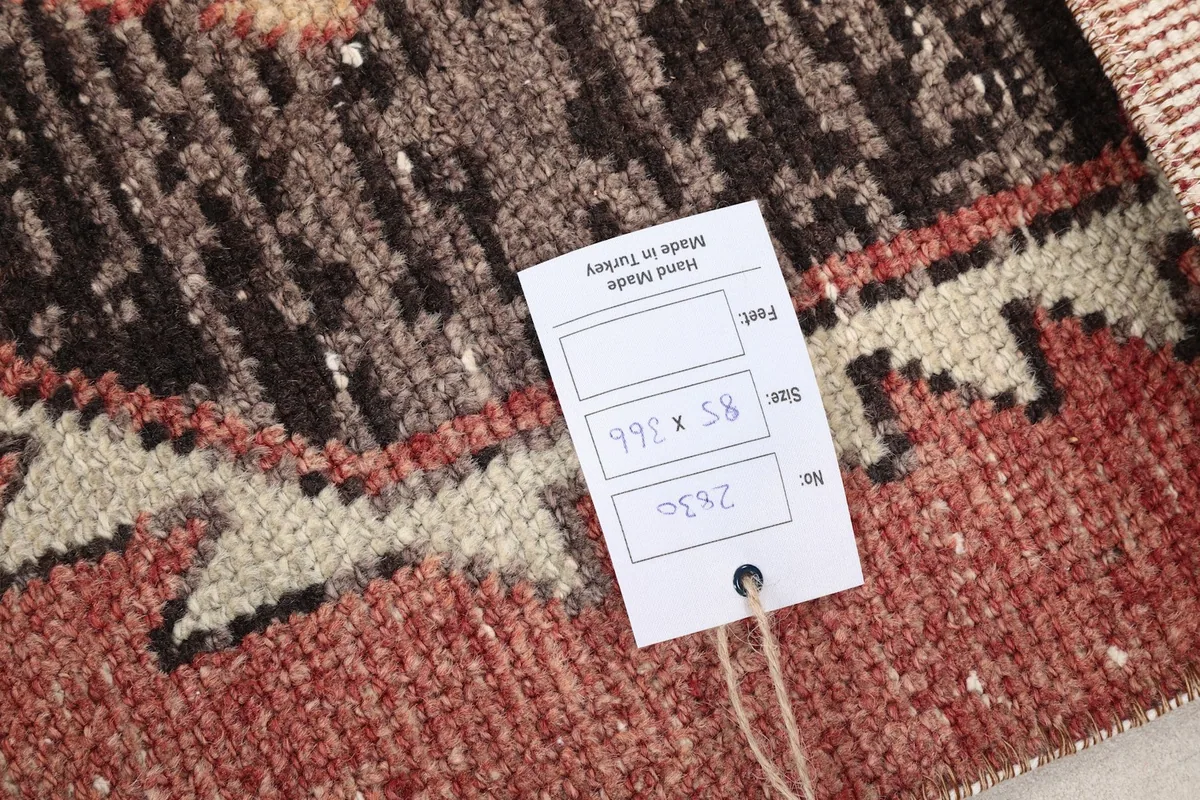 Close-up of the rug's label, indicating its hand-made origin and dimensions
