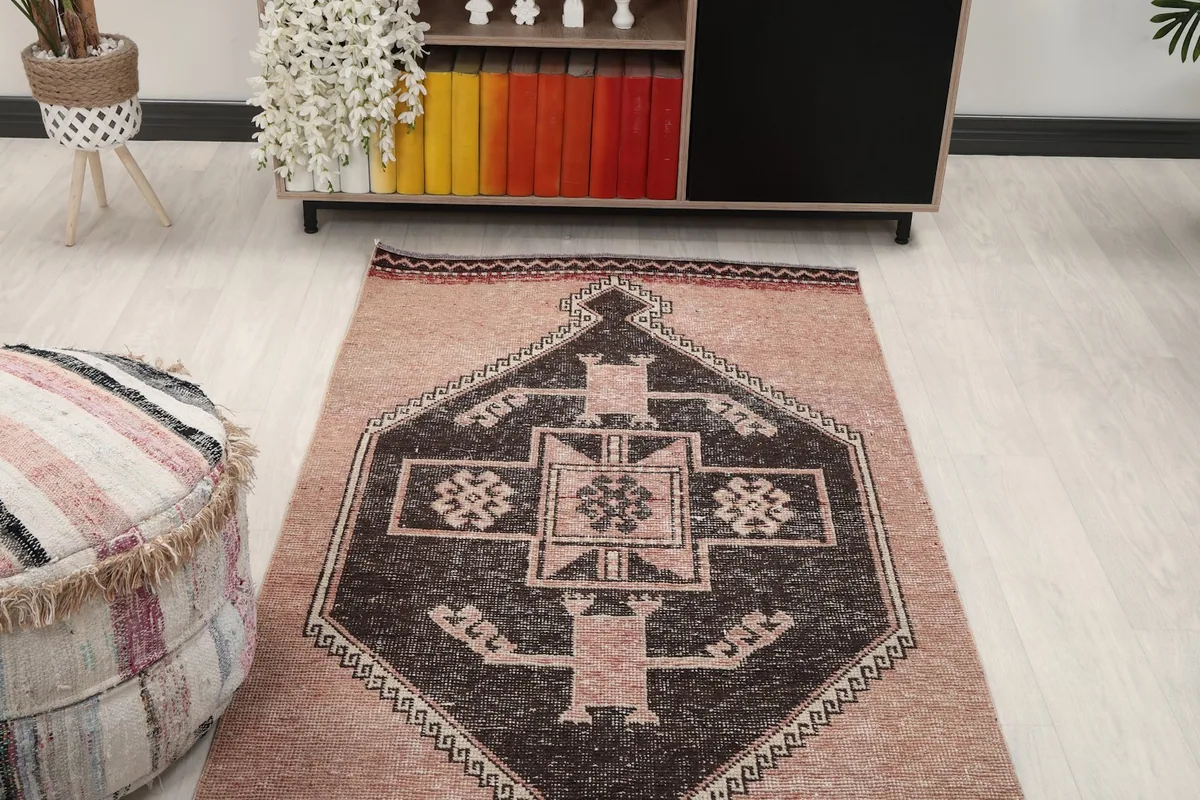 View of one end of the runner rug in a room setting, showing its placement near a cabinet.