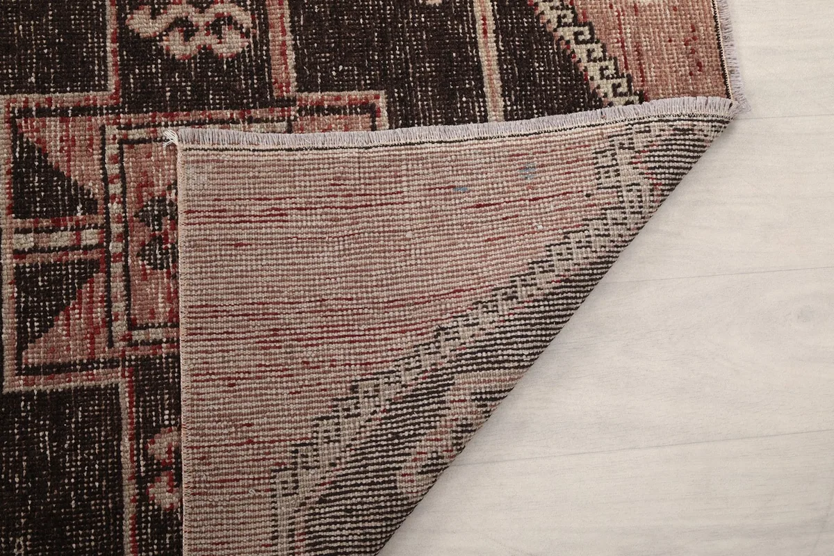 Detailed view of the rug's reverse side, showcasing the craftsmanship and tight knotting.