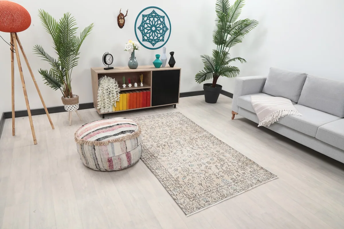 Angle view of the beige Anatolian rug in a living space, showing its size relative to furniture