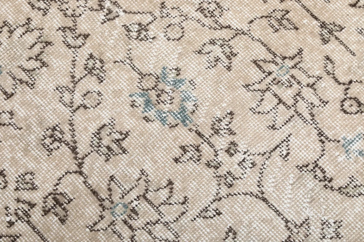 Macro shot of the hand-knotted wool pile, showing individual knots and color fade