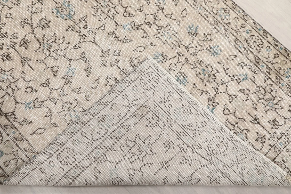 View of the rug's underside, revealing the cotton foundation and hand-knotted construction
