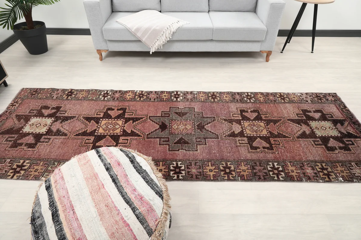 Rose Geometric Anatolian Runner centered in a modern room with a sofa