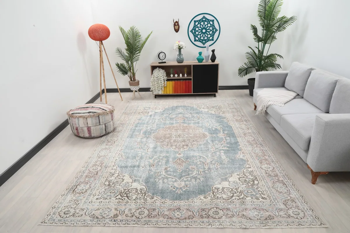 Vintage blue and rose area rug displayed in a modern living room setting