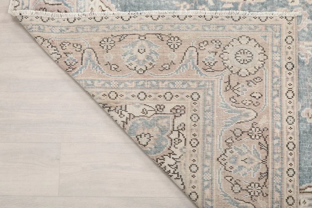 Underside corner detail, revealing the craftsmanship of the hand-knotted rug