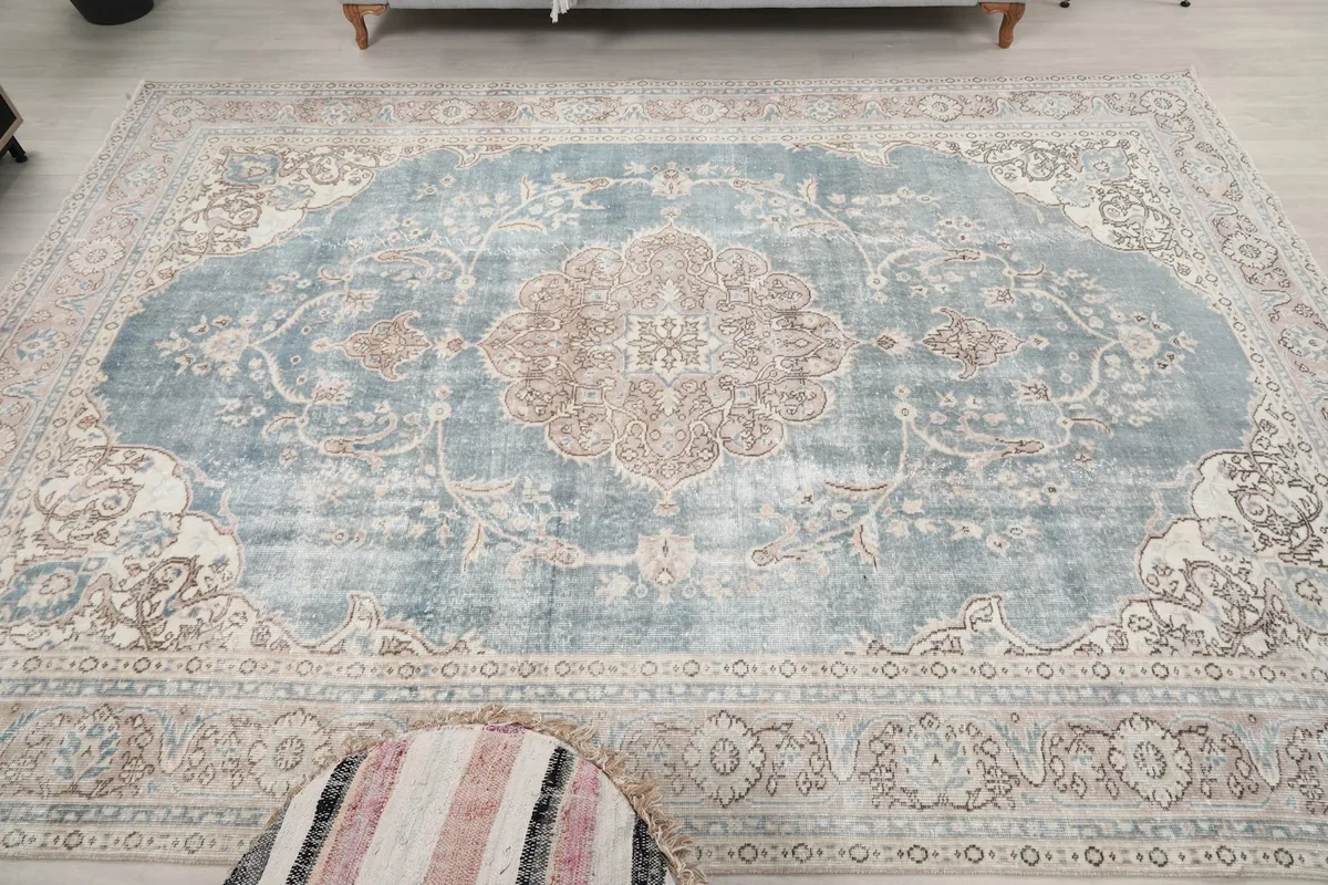 Overhead view of the vintage blue rug, emphasizing its shape and design
