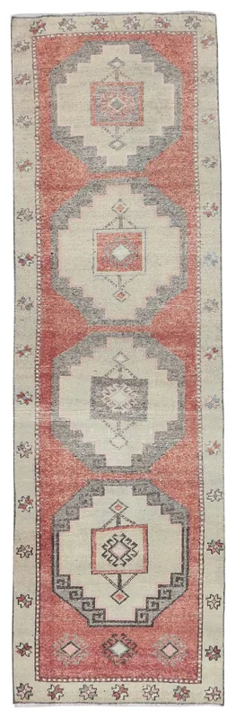 Full overhead view of a 3x9 vintage rust and beige geometric Anatolian runner rug