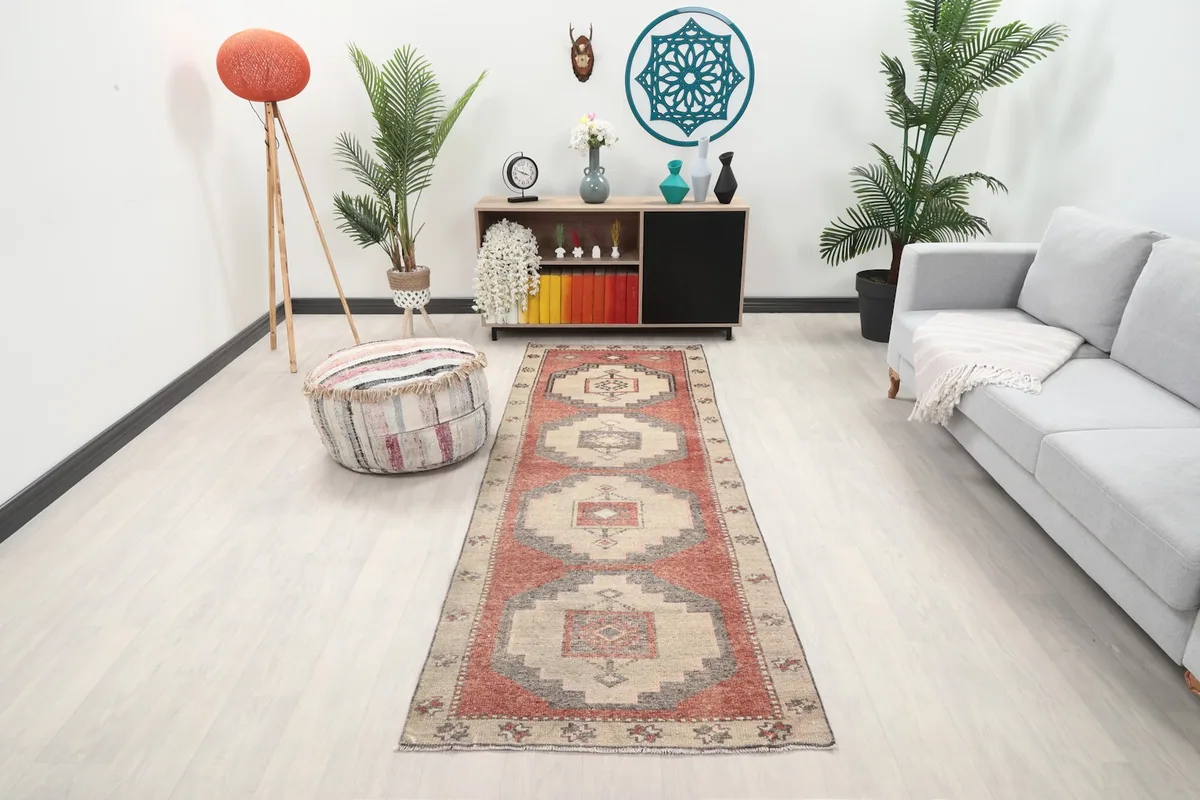 Vintage runner rug in a modern living room setting with a couch and console