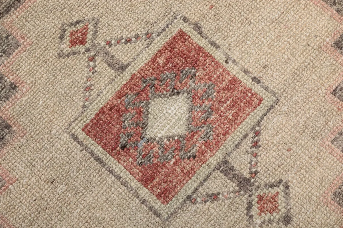 Intricate detail of the hand-knotted wool pile and small geometric patterns