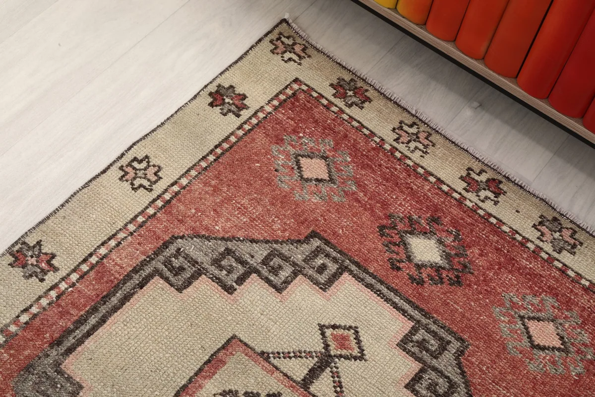 Detailed view of the rug's border and corner motif with small floral designs