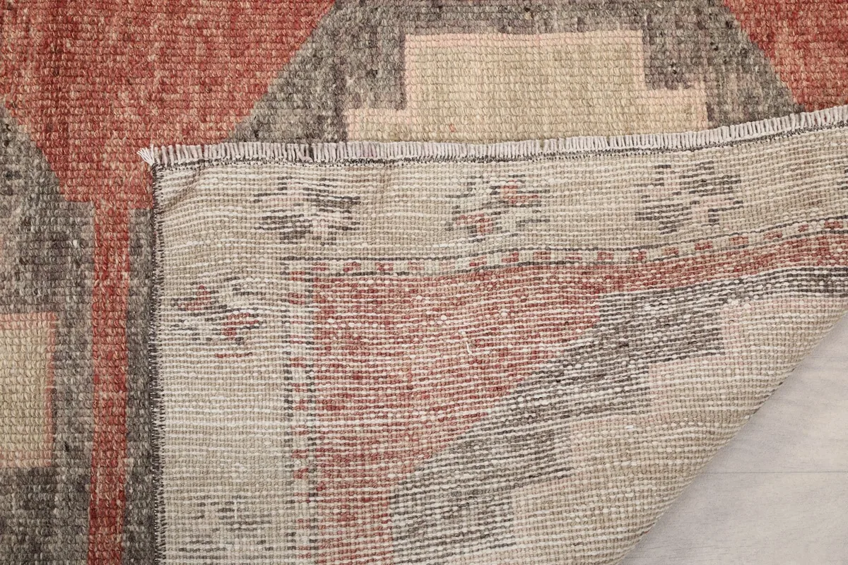 Underside of the rug, revealing the tight hand-knotted construction and fringe