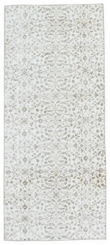 Full overhead view of the 2'7" x 6'4" cream and brown floral vintage Anatolian runner on a white background.
