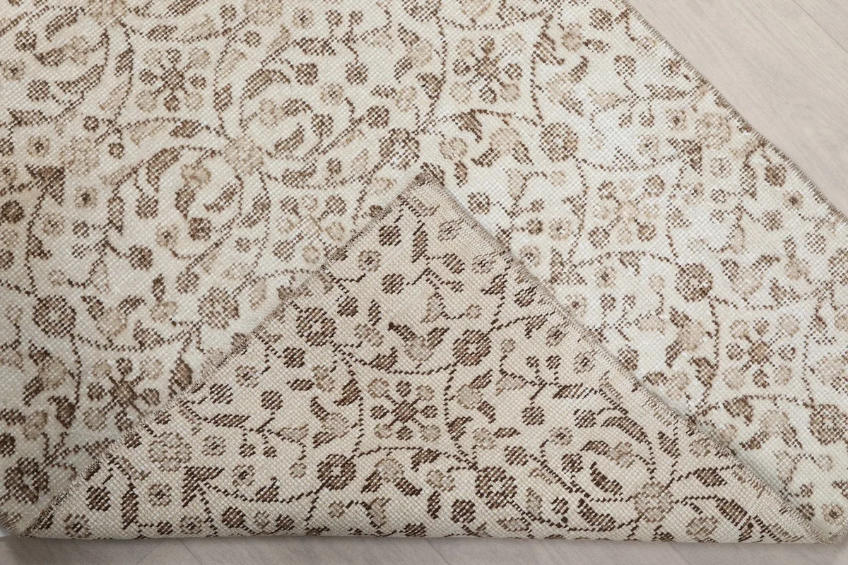 Underside view of the rug, revealing the cotton foundation and hand-knotted construction.
