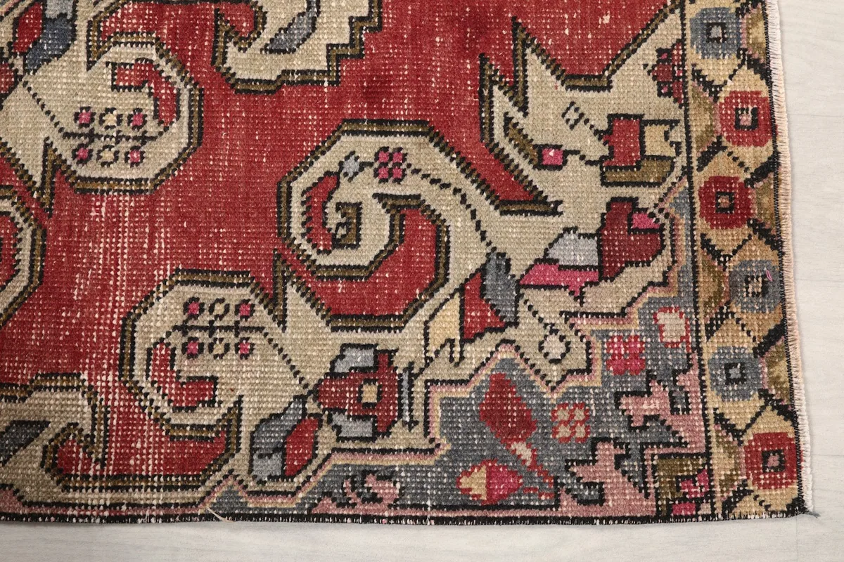 Detailed view of the corner motif and border, showing the hand-knotted wool texture and colors.