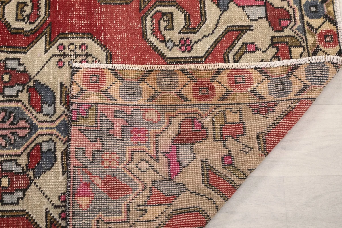 Close-up of the rug's back, showing the consistent hand-knotted structure and fringe.