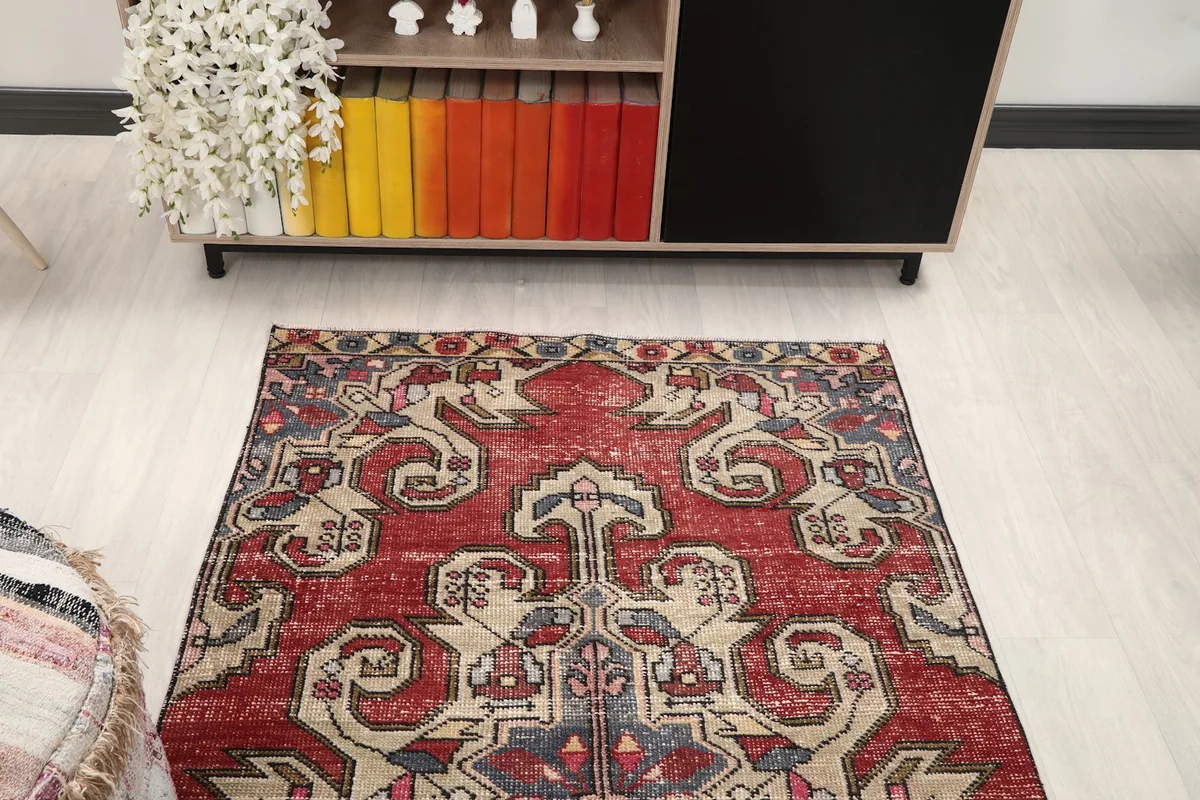 Overhead view of the rug's top half, showcasing the medallion and tribal patterns.