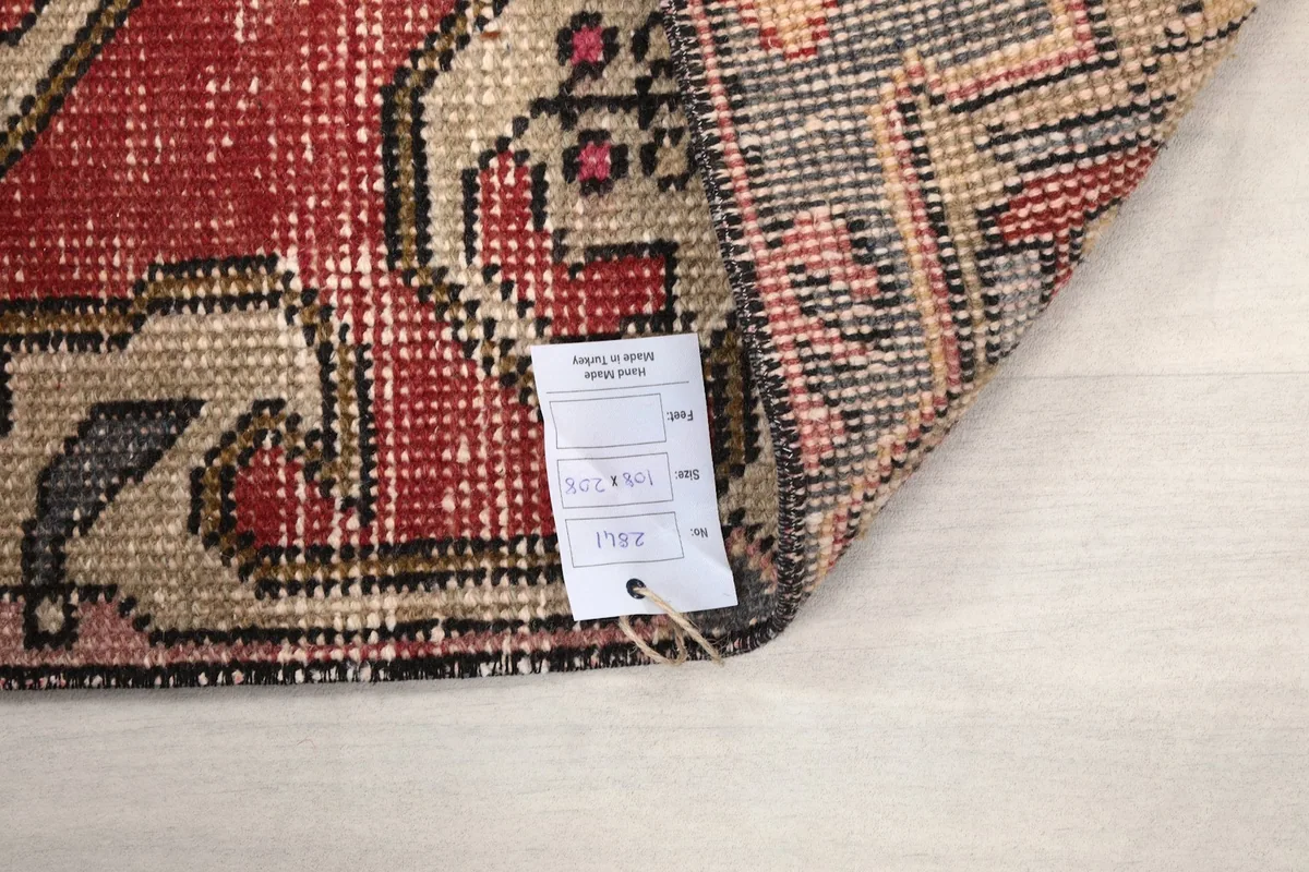Detail of the rug's label, indicating its origin and material composition.