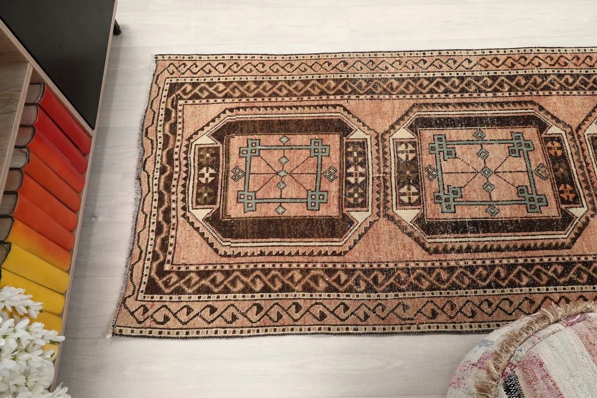 Angled view of the rug's top section, showing multiple medallions