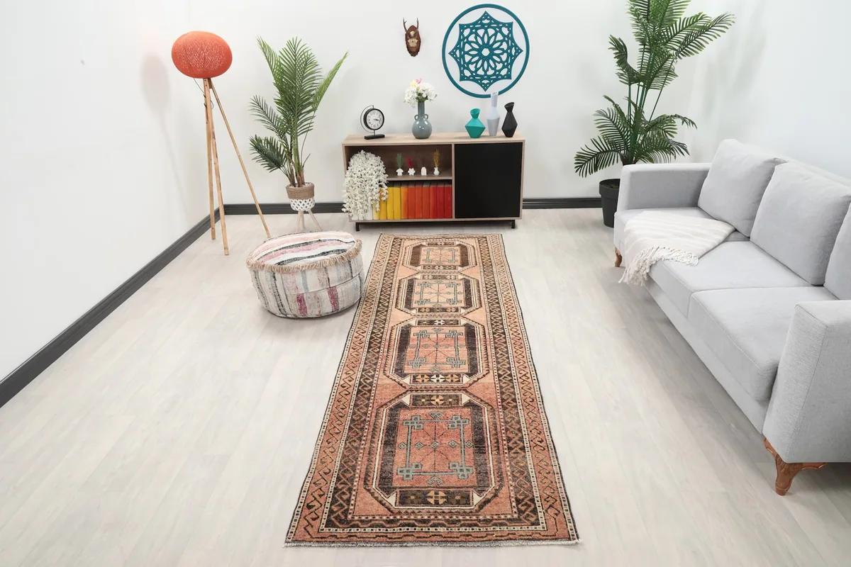 Vintage runner rug in a modern living space with light flooring and gray sofa