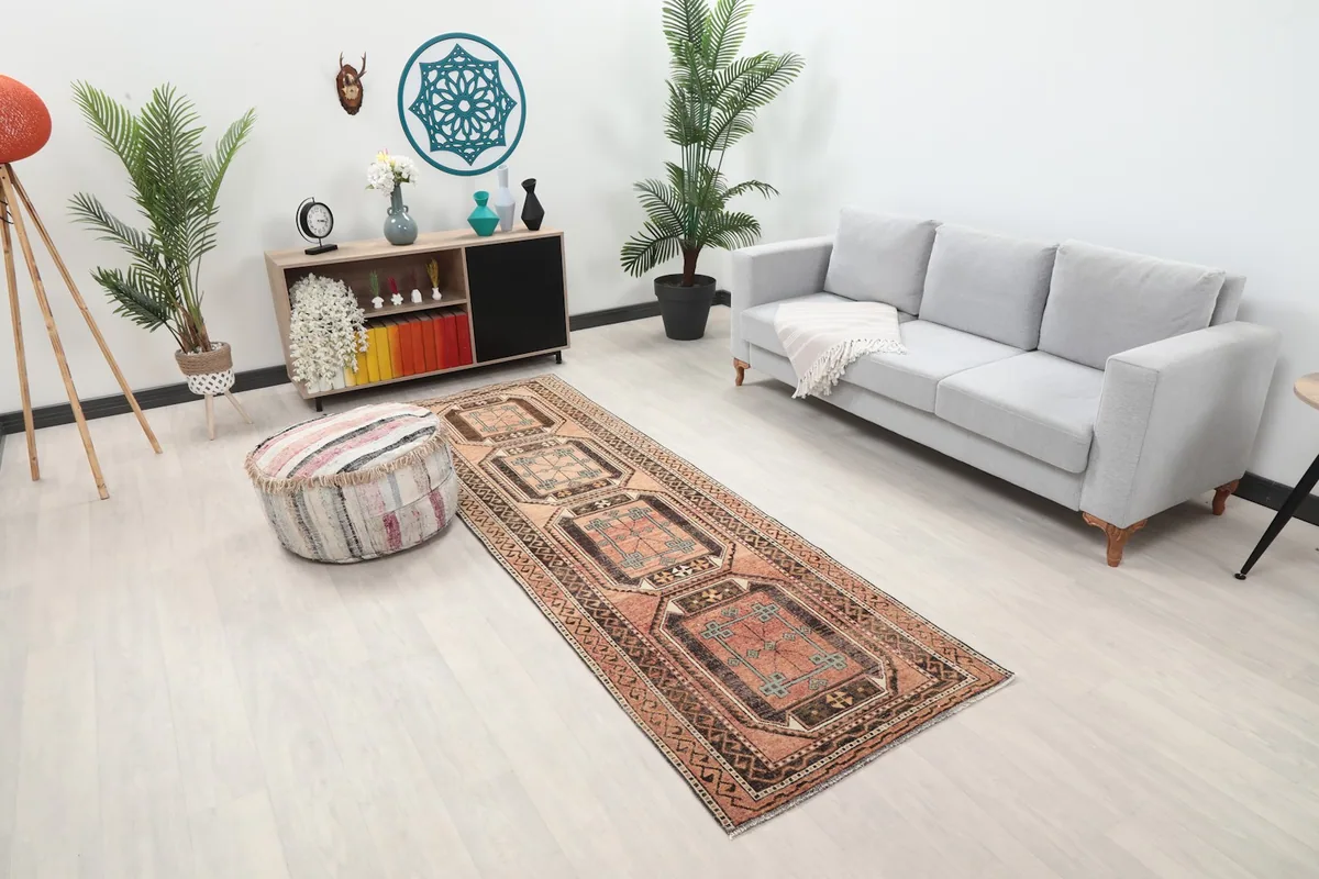 Angled view of the rose and brown runner rug in a room setting