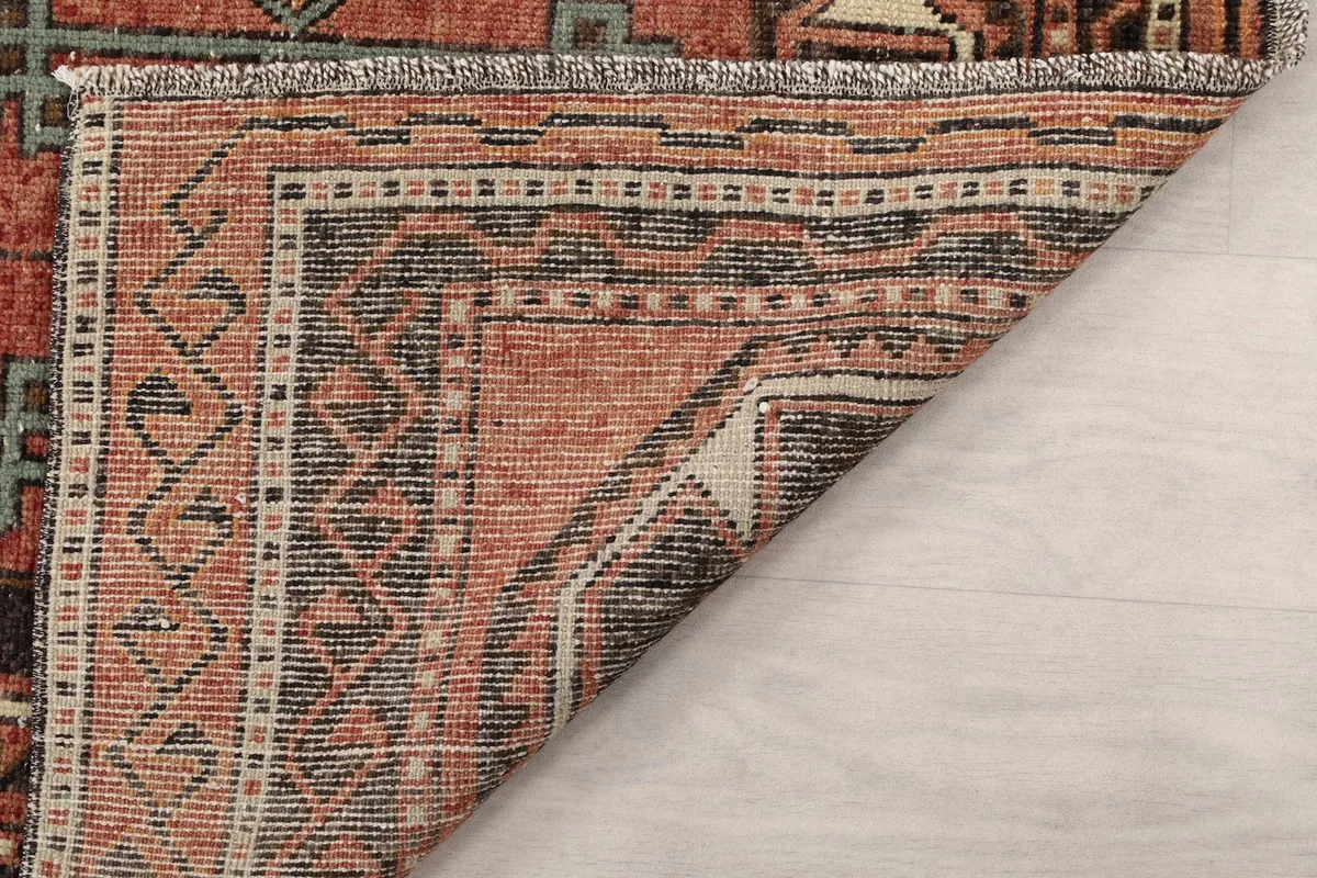 Another view of the rug's folded corner, revealing the cotton foundation