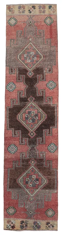 Full overhead view of the rust and brown geometric Anatolian runner on a white background.